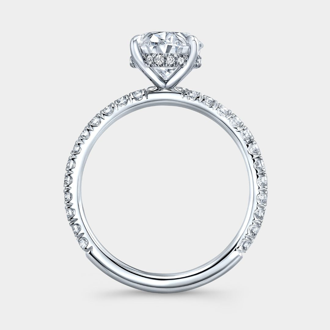 Diamond ring with a heart-shaped center stone on a light gray background