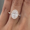Video of oval diamond rose gold ring with seamless halo and marquise-round diamond details