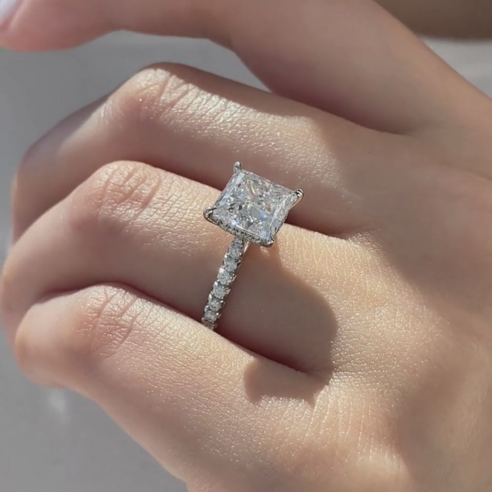 Video of princess diamond platinum ring with cathedral setting and French pavé detail